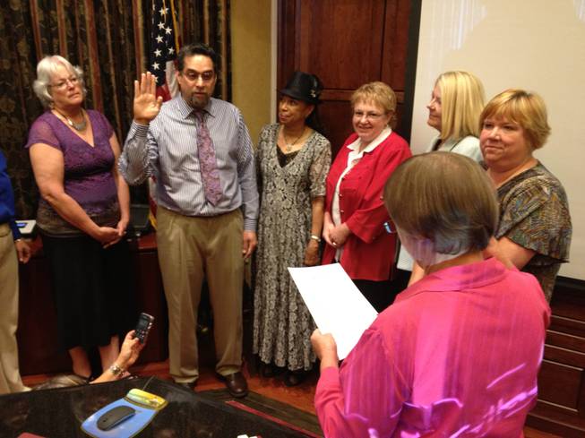 Rene Cantu Jr., center, is sworn in as the District E representative on the Clark County School Board on Thursday, July 19, 2012, as other School Board members watch. From left are, Carolyn Edwards, Cantu, Board President Linda Young, Chris Garvey, Lorraine Alderman and Deanna Wright, Cantu, executive director of the Las Vegas Latin Chamber of Commerce, will serve the remaining five months of the term ending Jan. 7, 2013.