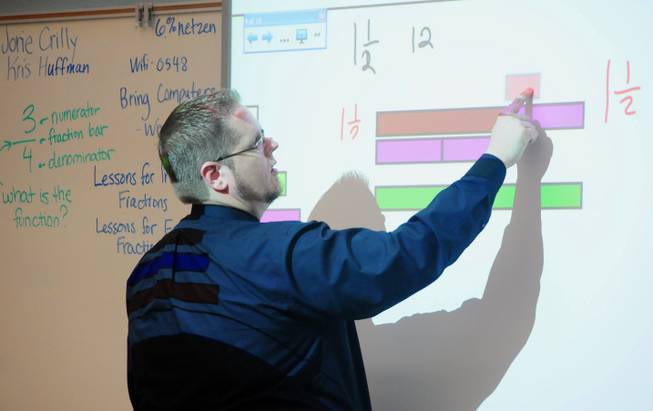 Williams Elementary School K-5 instructional coach Kris Huffman teaches math concepts using a "smartboard" during a summer training session on Tuesday, July 24, 2012. More than 5,000 Clark County School District teachers are taking unprecedented professional development opportunities over the summer in a district-wide initiative to boost student achievement in the upcoming school year.