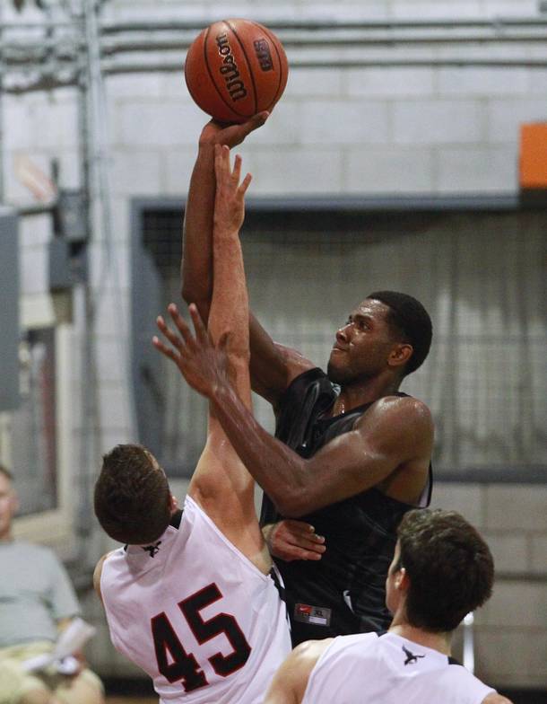 UNLV forward Mike Moser shoots over the top of Carleton University forward Dan Penner during their game in Ottawa, Ontario, Saturday, Aug. 18, 2012. The Rebels won the game 74-70, the first in a four-game exhibition tour in Canada.