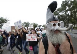 Demonstrators chant and walk during a protest march, Sunday, Aug. 26, 2012, in St Petersburg, Fla. Hundreds of protestors gathered a park in downtown St. Petersburg to march in demonstration against the Republican National Convention. 