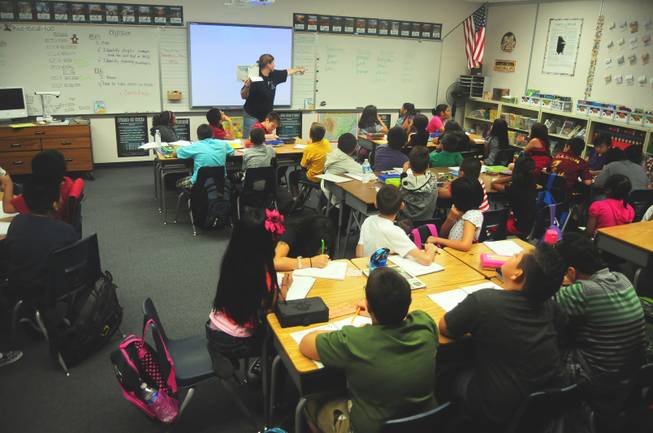 Decker Elementary School teacher Kim Jeter reads to a 51-student fourth grade class on Wednesday, Sept. 5, 2012. The air-conditioning system at the nearby Diskin Elementary school, a 39-year-old school that was last renovated 12 years ago, failed on Tuesday, prompting school officials to temporarily close the school and transfer Diskin students to Decker on Wednesday.