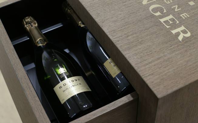 A limited edition 50th anniversary cabinet containing twelve vintages of Bollinger R.D. Champagne is seen at the James Bond movie memorabilia charity auction at Christie's auction house in London, Friday, Sept. 28, 2012. Bollinger was first asked for in a Bond movie by Roger More in 'Live and Let Die' in 1974, and has been used several times since .The champagne is expected to raise some 10-15,000 British pounds ($16,-23,000, euro 12-17,000) with the proceeds going to UNICEF.