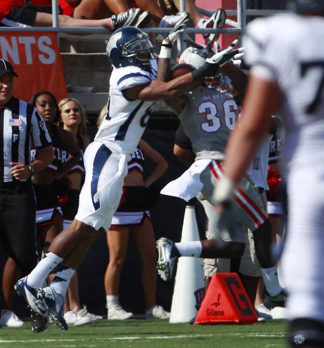 In a pivotal play, UNLV defensive back Sidney Hodge appears to intercept a pass intended for UNR wide receiver Aaron Bradley during their game Saturday, Oct. 13, 2012 at Sam Boyd Stadium. The play was nullified when Hodge was called for pass interference. UNR came from behind and won the game, for the eighth consecutive time, 42-37.