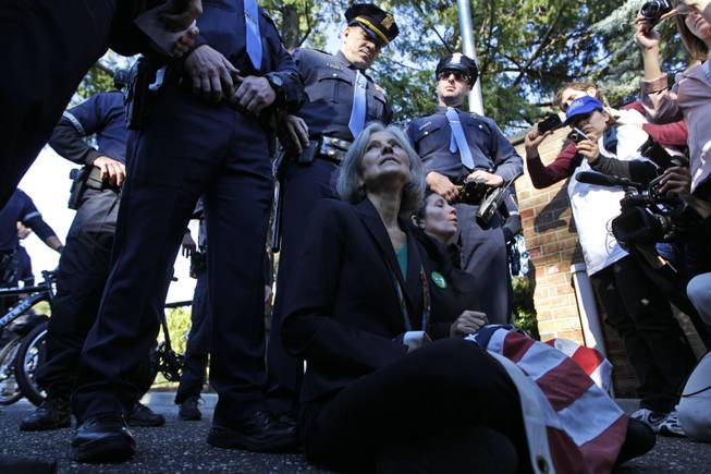Green Party presidential candidate Jill Stein, left, and vice presidential candidate Cheri Honkala sit at the entrance to Hofstra University, Hempstead, N.Y., Tuesday, Oct. 16, 2012, after being informed that they wouldn't be able to enter and participate in the second presidential debate.