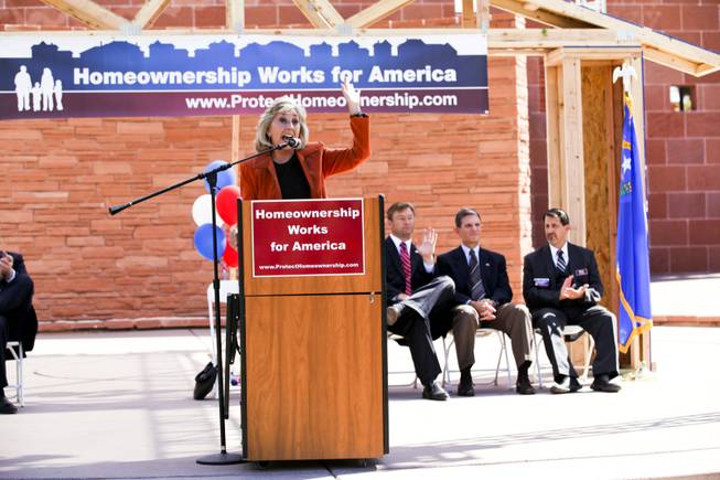 Former Rep. Dina Titus, running for Nevada's 1st Congressional District seat, asks for a show of hands of those who have been affected by foreclosures in the housing crisis at a homeownership rally at the Clark County Government Center Amphitheater in Las Vegas Thursday, Oct. 18, 2012. Titus and Sen. Dean Heller raise their hands; Rep. Joe Heck of the 3rd Congressional District does not.