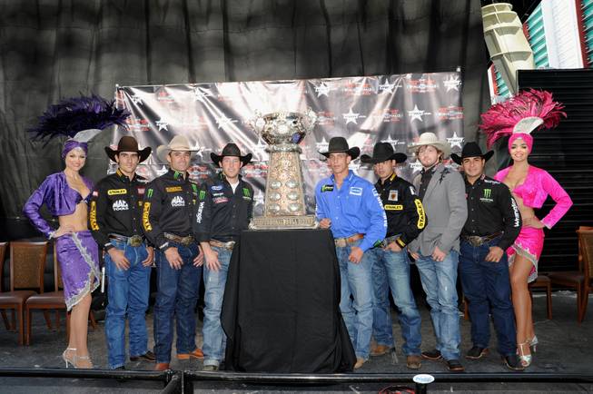 Seven of the Top 10 bull riders in the world gathered Monday, Oct. 22, 2012, at Fremont Street Experience to kick off the 2012 PBR Built Ford Tough World Finals (Oct. 24-28). From left with showgirls: 2011 defending world champion Silvano Alves (Brazil); Guilherme Marchi (Brazil); L.J. Jenkins (Oklahoma); J.B. Mauney (North Carolina); Marco Eguchi (Brazil); Austin Meier (Oklahoma); and Robson Palermo (Brazil).
