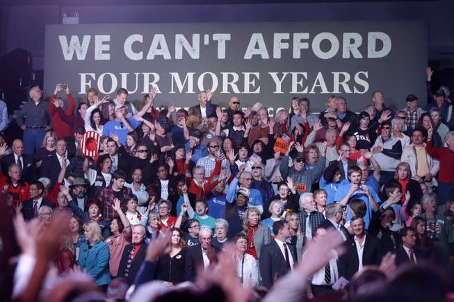 Audience members raise their hands in the air during a musical performance of "Glory, Glory" before Republican presidential candidate, former Massachusetts Gov. Mitt Romney arrives to speak at an election campaign rally at the Reno Event Center in Reno, Nev., Wednesday, Oct. 24, 2012.