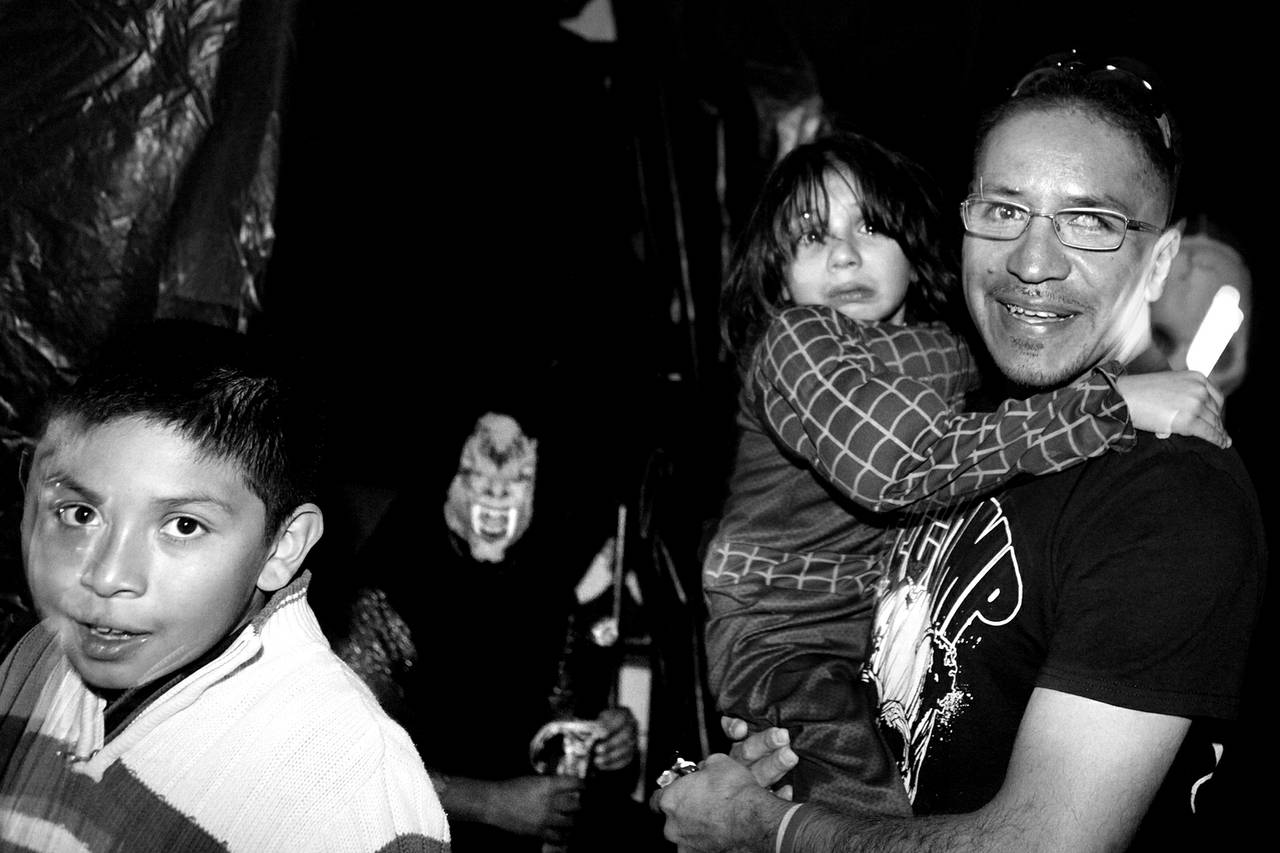 Arturo Martinez-Sanchez takes his sons Cristopher, left, 10, and Alejandro, 5, through a haunted house while trick-or-treating with friends from his old neighborhood in Las Vegas on Oct. 31, 2012.