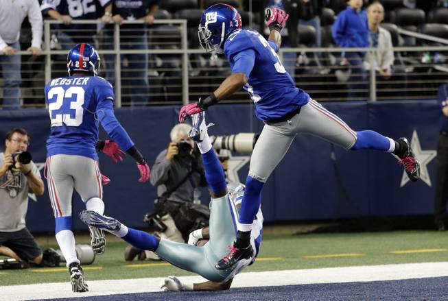 Dallas Cowboys wide receiver Dez Bryant (88) makes a last-minute reception between New York Giants cornerbacks Corey Webster (23) and Michael Coe (37) for a touchdown that was nullified after review during an NFL football game, Sunday, Oct. 28, 2012, in Arlington, Texas. Bryant's hand landed on the line. The Giants won 29-24.