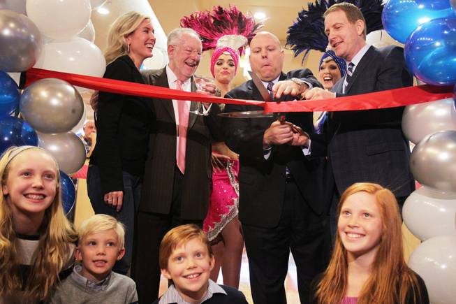 The ribbon cutting ceremony is performed by Lincoln Spoor, from top right, CEO of Feel Good Brands, Jason Shkorupa, vice president of food and beverage for Luxor and Excalibur, former Mayor Oscar Goodman, and Spoor's wife Sarah Spoor during the grand opening of Castle Walk Food Court at the Excalibur in Las Vegas on Tuesday, November 20, 2012. Spoor's children Blakely, from left, 11, Campbell, 6, Walker, 8, and Savannah, 10, are seated in front.