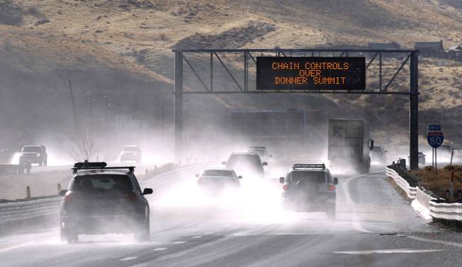 Traffic moves west along Interstate 80 west of Reno as a heavy, wet storm hits Northern Nevada on Sunday, Dec. 2, 2012. A powerful storm delivered more snow and less rainfall Sunday to the Sierra than forecast, blunting the flooding danger on the Truckee River in California and Nevada, forecasters said.