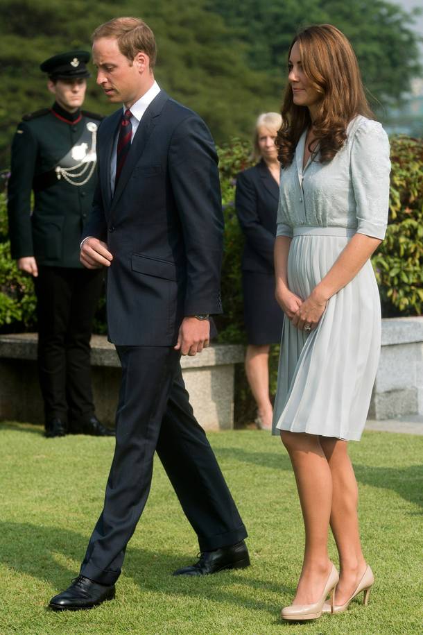 In this Thursday, Sept. 13, 2012 file photo, Britain's Prince William and his wife Kate, the Duke and Duchess of Cambridge, walk together as they visit the Kranji Commonwealth War Memorial in Singapore.