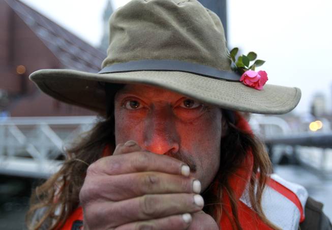 Michael Richard Smith lights a cigarette while speaking with members of the media on a wharf in Boston Harbor, in Boston, Tuesday, Dec. 4, 2012. The 49-year-old Maine native said Tuesday that he’s been paddling the waters of metro Boston since at least late summer with all of his possessions aboard a 14-foot, 40-year-old aluminum canoe that he patches with duct tape when necessary.
