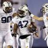 BYU linebacker Ezekiel Ansah, center, is congratulated by Bronson Kaufusi, left, and Daniel Sorensen after intercepting a San Diego State pass during the first half of the Poinsettia Bowl, Thursday, Dec. 20, 2012, in San Diego. BYU linebacker Ezekiel Ansah, center, is congratulated by Bronson Kaufusi, left, and Daniel Sorensen after intercepting a San Diego State pass during the first half of the Poinsettia Bowl, Thursday, Dec. 20, 2012, in San Diego.