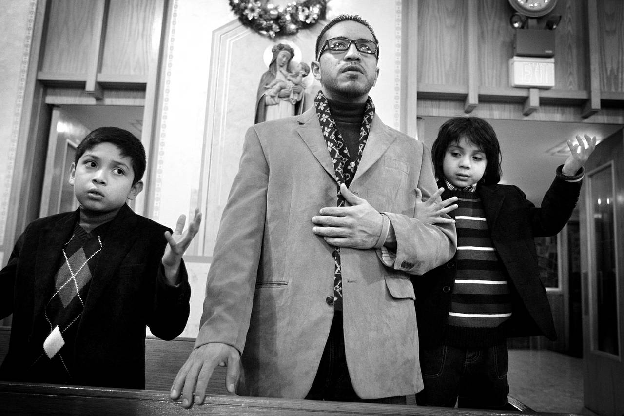 Arturo Martinez-Sanchez, center, attends Christmas Eve Mass with his sons, Cristopher, 10, left, and Alejandro, 5, at St. Christopher Catholic Church in North Las Vegas on Dec. 24, 2012.