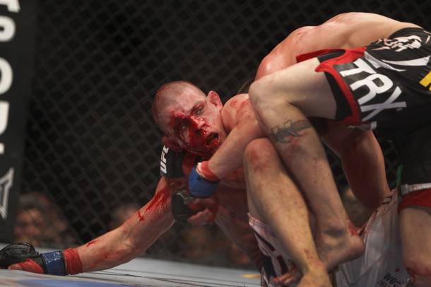 Joe Lauzon, left, of Bridgewater, Mass. bleeds from cuts on his face as he fights Jim Miller of Whippany, N.J.during a lightweight bout UFC155 at the MGM Grand Garden Arena Saturday, Dec. 29, 2012.