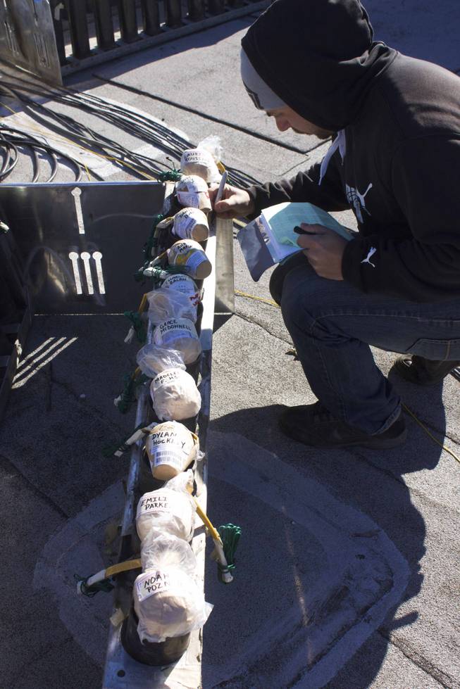Anthony Mortati, pyrotechnician for Fireworks by Grucci, numbers fireworks in preparation for the Las Vegas Strip New Year's Eve show, Monday, Dec. 31, 2012. As a memorial for the Sandy Hook Elementary School shooting, the technicians wrote the names of the 26 victims on individual fireworks.