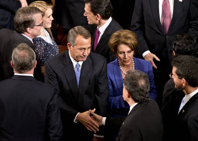House Speaker John Boehner of Ohio enters the House of Representatives chamber on Capitol Hill in Washington, Thursday, Jan. 3, 2013, after surviving a roll call vote in the newly convened 113th Congress. He is escorted by House Majority Leader Eric Cantor of Virginia, and House Minority Leader Nancy Pelosi of California.
