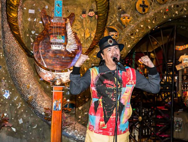 Artist Dale Evers' 13-foot guitar sculpture for Carlos Santana and House of Blues is unveiled at HOB in Mandalay Bay on Wednesday, Jan. 16, 2013. Santana, Evers (in black) and Paul Reed Smith (in striped shirt) of PRS Guitars attended the unveiling.