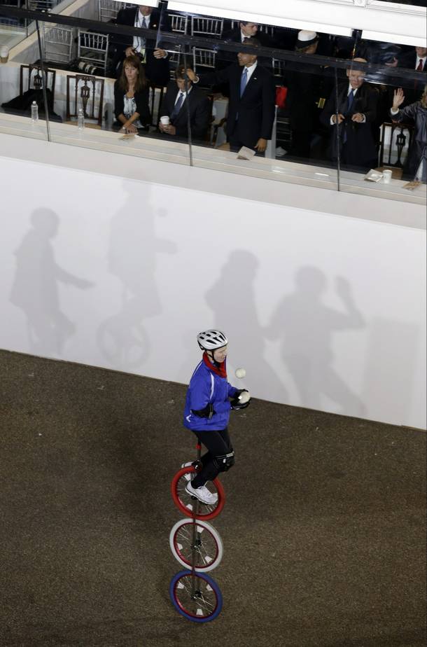 A member of the Gym Dandies Children's Circus, Maine, moves past the presidential box on Pennsylvania Avenue en route to the White House, Monday, Jan. 21, 2013, in Washington. Thousands marched during the 57th Presidential Inauguration parade after the ceremonial swearing-in of President Barack Obama.