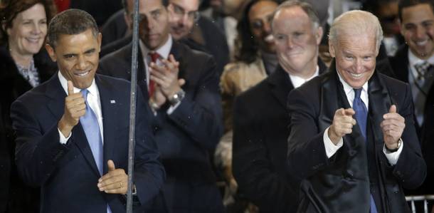 President Barack Obama and Vice President Joe Biden react during the inaugural parade on Pennsylvania Avenue near the White House, Monday, Jan. 21, 2013, in Washington. Thousands marched during the 57th Presidential Inauguration parade after the ceremonial swearing-in of President Barack Obama.