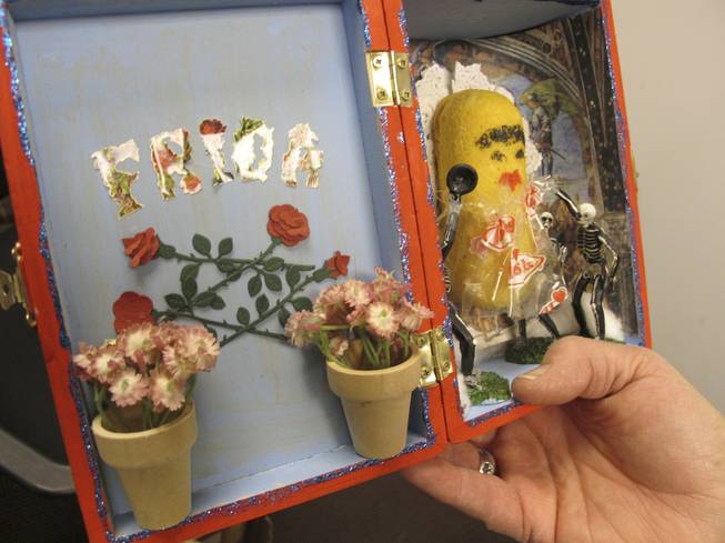 In this Dec. 14, 2012, photo, Artist Nancy Peppin holds one of her creations from her series "Day of the Dead Twinkies" one of dozens of pieces of art she has created over the years using Twinkies and other Hostess products, in Reno, Nev. A graphic artist by day for slot machine-maker International Game Technology, Peppin doesn't like to eat Twinkies. She uses them to depict popular culture similar to the work of Andy Warhol.