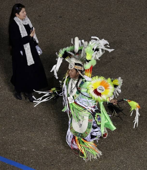 Wind River Dancers, Wyoming, perform while passing the presidential box and the White House during the Inaugural parade, Monday, Jan. 21, 2013, in Washington. Thousands marched during the 57th Presidential Inauguration parade after the ceremonial swearing-in of President Barack Obama.