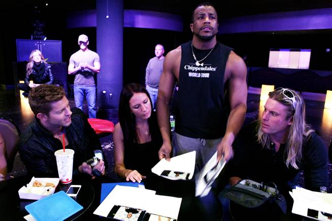 Chippendales cast member Jaymes Vaughan, from left, production tour manager Allie Hahn, world tour dance captain Bryan Cheatham and world tour manager Kevin Cornell evaluate hopefuls during auditions for the Chippendales World Tour at the Chippendales Theater inside The Rio in Las Vegas on Wednesday, Jan. 23, 2013.