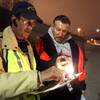 Photo: Guide Neil Jurgensen, left, helps volunteer Ken Lo Photo: Guide Neil Jurgensen, left, helps volunteer Ken Lo
