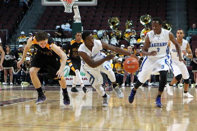 After stealing the ball from Clark guard Carter Olsen, left, Desert Pines Malik Davis takes the ball up court during their Class 1A basketball championship game Saturday, Feb. 23, 2013 at the Orleans Arena. After trailing almost the whole game, Desert Pines came from behind to win 59-57