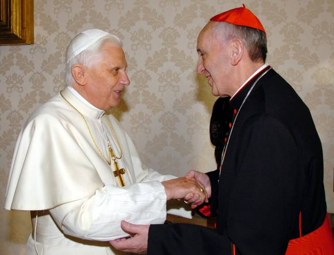 This Jan. 13, 2007 file photo provided by the Vatican newspaper L'Osservatore Romano, then Pope Benedict XVI, left, shakes hands with the archbishop of Buenos Aires Cardinal Jorge Mario Bergoglio during their meeting at the Vatican, Saturday, Jan. 13, 2007. Bergoglio, who took the name of Pope Francis, was elected on Wednesday, March 13, 2013 the 266th pontiff of the Roman Catholic Church.