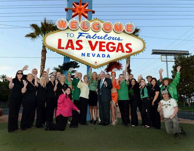 Clark County Commissioner Chris Giunchigliani (in yellow), "The Voice Ireland" host Kathryn Thomas and former Mayor Oscar Goodman, the Las Vegas Convention and Visitors Authority Host Committee chairman, are flanked by staff from Ri Ra Irish Pub at Mandalay Bay and showgirls at the Welcome to Fabulous Las Vegas sign on Wednesday, March 13, 2013.