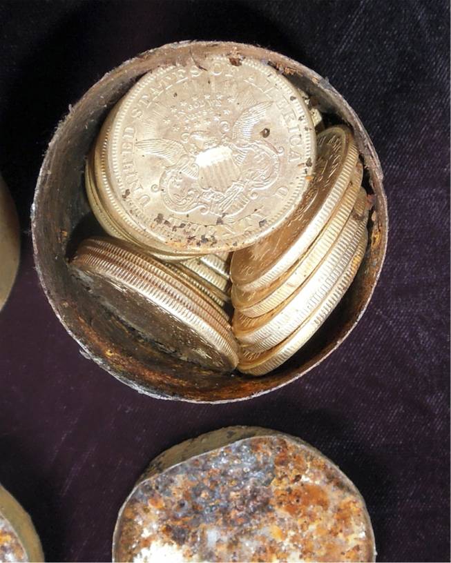 This image provided by the Saddle Ridge Hoard discoverers via Kagin's, Inc., shows one of the six decaying metal canisters filled with 1800s-era U.S. gold coins unearthed in California by two people who want to remain anonymous. The value of the "Saddle Ridge Hoard" treasure trove is estimated at $10 million or more.