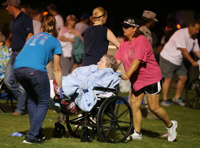 An elderly person is assisted at a staging area at a local school stadium following an explosion at a fertilizer plant Wednesday, April 17, 2013, in West, Texas. An explosion at a fertilizer plant near Waco caused numerous injuries and sent flames shooting high into the night sky on Wednesday.