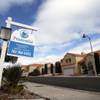 Photo: A realty sign is posted in front of home in the La Photo: A realty sign is posted in front of home in the La