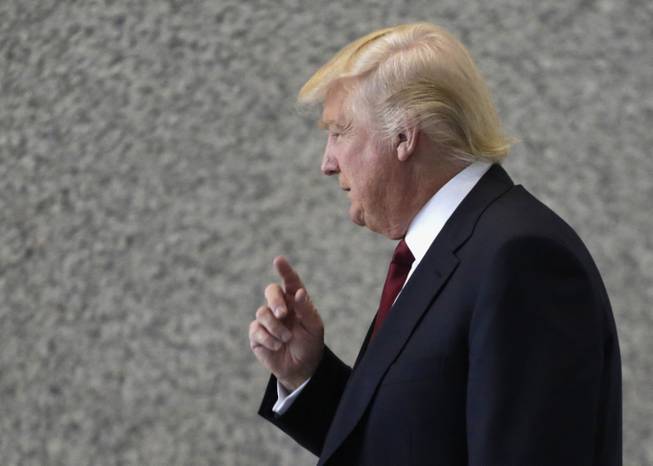 In this May 14, 2013, file photo, Donald Trump arrives at federal court in Chicago to testify at a civil trial where he is accused of cheating an 87-year-old Jacqueline Goldberg in a condo deal. On Thursday, May 23, 2013, jurors sided with Trump and against Goldberg. Goldberg claimed the real estate mogul-turned-TV star carried out a bait and switch by offering her profit sharing in his namesake Chicago tower and reneging only after she committed to buy.