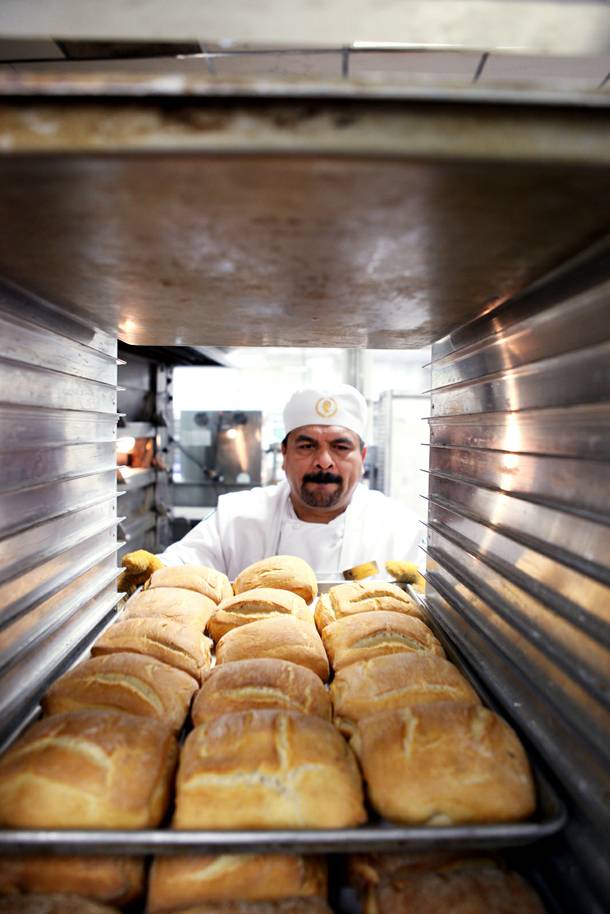 Baker Carlos Meza racks fresh bread inside the basement bakery at Caesars Palace in Las Vegas on Tuesday, June 11, 2013.