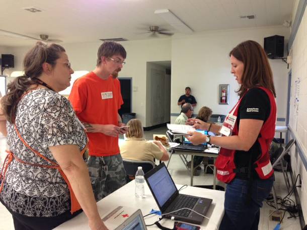 Teresa Awkeman, specialty manager at the Home Depot in Pahrump and Herb Dinardi, department supervisor at the Home Depot at 9705 W Charleston Blvd.
in Las Vegas, work with Jennifer Ramieh, a spokeswoman for the Southern Nevada Chapter of the American Red Cross, to donate water for Mount Charleston wildfire evacuation shelters on July 5, 2013.