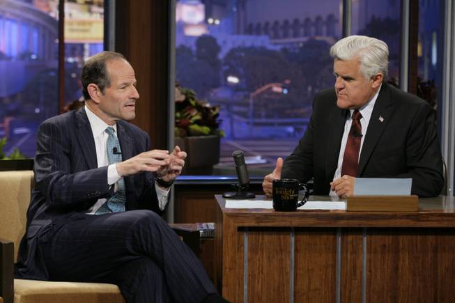 This publicity image released by NBC shows former New York Gov. Eliot Spitzer, left, talking with host Jay Leno during a taping of "The Tonight Show with Jay Leno," Friday, July 12, 2013, in Burbank, Calif. Spitzer, who resigned as governor in 2008 amid a prostitution scandal, is now running for New York City comptroller.