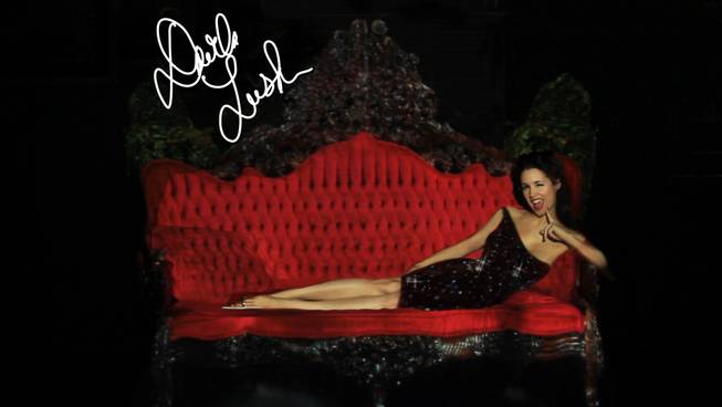 Although completely nude, burlesque performer Darla Lush appears to be clothed using projection mapping technology at the El Cortez on Tuesday, July 23, 2013. She plans to incorporate the technology into her striptease act. The couch she is sitting on is also projection mapped -- in real life it looks nothing like the one in this picture.
