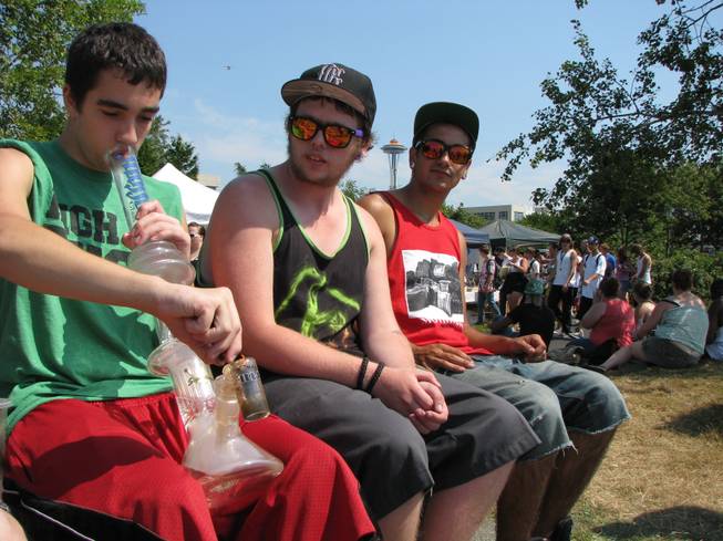 Matt Galanti, 17, of Bothell, Wash., smokes marijuana from a glass bong at the opening day of the pro-marijuana rally Seattle Hempfest, Aug. 17, 2012, as friends Zach Casselman, 18, of Bothell, and Clay Graeber, 20, of Bothell, look on. Organizers expected more than 150,000 people to attend the three-day event, which comes as citizens in Washington state prepare to vote on an initiative that would legalize and tax the sale of up to an ounce of cannabis at state-licensed stores.
