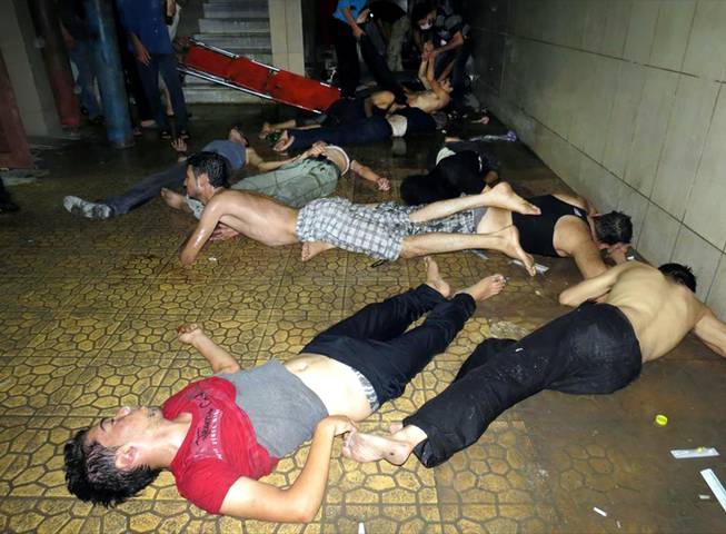 This citizen journalism image provided by the Media Office Of Douma City which has been authenticated based on its contents and other AP reporting, shows Syrian men lying on the ground as they wait for treatment after an alleged poisonous gas attack fired by regime forces, according to activists in Douma town, Damascus, Syria, Wednesday, Aug. 21, 2013.