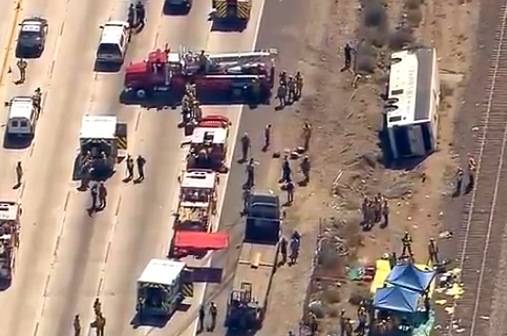 This video image provided by KABC-TV shows rescue officials working the scene of an accident where a tour bus, left, crashed and turned over injuring multiple passengers Thursday Aug. 22, 2013 in Los Angeles. Los Angeles County fire officials say 50 people have been injured in the tour bus crash along a Southern California freeway.
