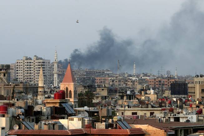 Columns of smoke rising from heavy shelling in the Jobar neighborhood in west Damascus, in Cairo, Syria, Thursday, Aug. 22, 2013. President Bashar Assad's forces pressed on with a military offensive in eastern Damascus on Thursday, bombing rebel-held suburbs where the opposition said a chemical weapons attack the day before killed over 100 people. The government has denied allegations it used chemical weapons in artillery barrages on the area known as eastern Ghouta on Wednesday as "absolutely baseless."