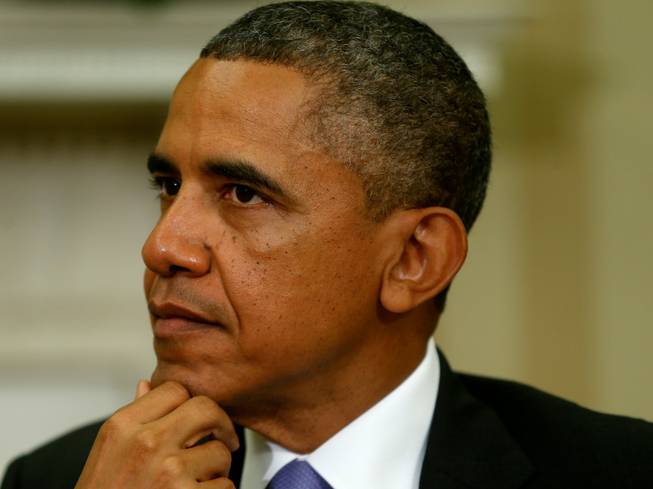 In this July 25, 2013 file photo, President Barack Obama listens in the Oval Office at the White House in Washington. A newly approved U.S. aid package of weapons to Syrian rebels may be too little, too late to reverse recent battlefield gains by President Bashar Assad — and few in Washington are enthusiastic about sending it. But the White House is pushing ahead nonetheless with the arms, which one official described as mostly light weapons, under the belief that doing something is better than doing nothing to help in the two-year Syrian civil war that has killed more than 100,000 people, even if the package is far less than what rebels say they need to turn the tide.