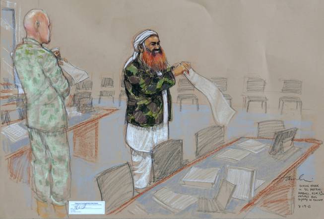 In this pool photo of a sketch by courtroom artist Janet Hamlin and reviewed by the U.S. Department of Defense, the self-proclaimed terrorist mastermind Khalid Sheikh Mohammed, with his gray beard streaked with reddish-orange dye, unfurls a prayer rug during a break in the proceedings of the pretrial hearings at the Guantanamo Bay U.S. Naval Base in Cuba, Monday, Aug. 19, 2013. Five Guantanamo Bay prisoners accused of helping orchestrate the Sept. 11 terrorist attacks returned to court Monday as arguments resumed. Lawyers for the five prisoners, who face charges that include murder and terrorism, began to challenge the statements made to U.S. federal agents such as James Fitzgerald of the FBI and Stephen McClain with the Criminal Investigative Task Force of the Department of Defense, who defended their interrogation of one of the detainees.