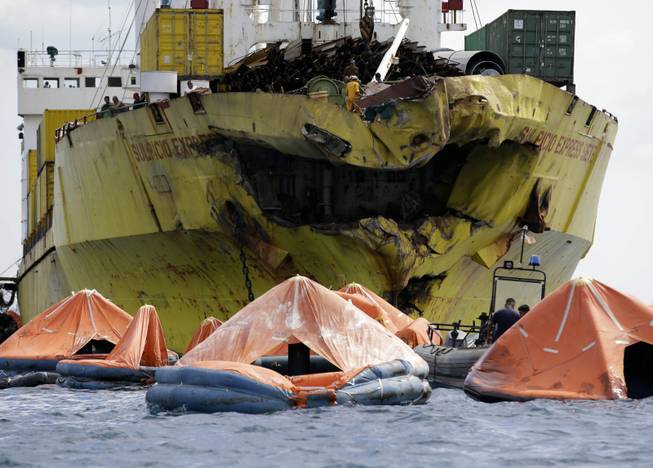 A cluster of life rafts is seen floating near the cargo ship Sulpicio Express Siete Saturday Aug.17, 2013, a day after it collided with a passenger ferry off the waters of Talisay city, Cebu province in central Philippines. Divers combed through a sunken ferry Saturday to retrieve the bodies of more than 200 people still missing from an overnight collision with a cargo vessel near the central Philippine port of Cebu that sent passengers jumping into the ocean and leaving many others trapped. At least 28 were confirmed dead and hundreds rescued. The captain of the ferry MV Thomas Aquinas, which was approaching the port late Friday, ordered the ship abandoned when it began listing and then sank just minutes after collision with the MV Sulpicio Express, coast guard deputy chief Rear Adm. Luis Tuason said.