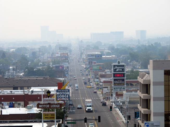 Hazy smoke from a wildfire more than 150 miles away near Yosemite National Park descended Thursday, Aug. 22, 2013, on Reno and the downtown casino district. Washoe County Health District officials issued an air quality alert because the Air Quality Index worsened to the unhealthy zone for sensitive groups, including the elderly and young children.
