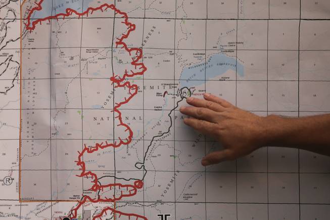 Operations Section Chief Glen Stratton points to the Hetch Hetchy Reservoir on the map while briefing the media at the command post near Yosemite National Park, Calif., on Monday, Aug. 26, 2013. Crews working to contain one of California's largest-ever wildfires gained some ground Monday against the flames threatening San Francisco's water supply, several towns near Yosemite National Park and historic giant sequoias.