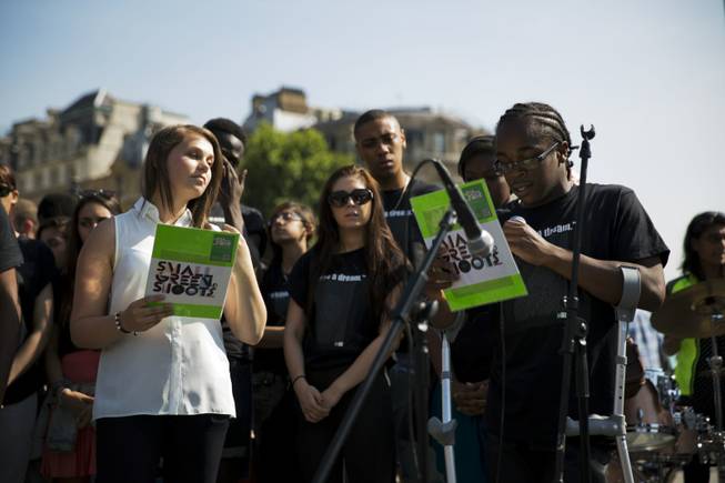 A youngster makes a reading after children took part in a freedom ring bell-ringing ceremony in Trafalgar Square, London, to mark 50 years since Dr. Martin Luther King delivered his "I Have A Dream" speech in Washington, Wednesday, Aug. 28, 2013. U.S. President Barack Obama was set to lead civil rights pioneers Wednesday in a ceremony for the 50th anniversary of the March on Washington, where Dr. Martin Luther King's "I Have a Dream" speech roused the 250,000 people who rallied there decades ago for racial equality. (AP Photo/Matt Dunham)